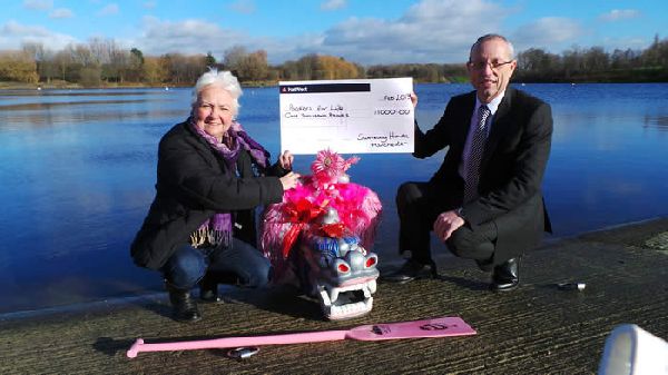 Anne accepts a cheque from Swansway who have generously supported the group enabling the them to keep a dragon boat at Debdale Activity Centre.